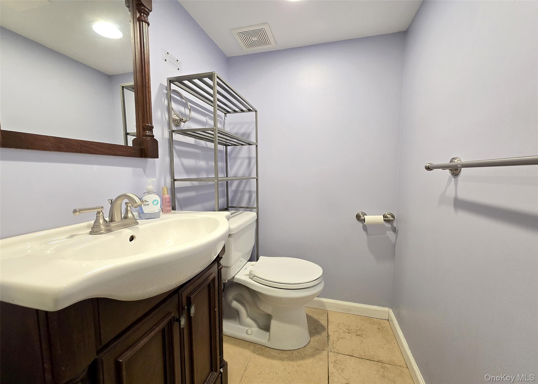 46 Harvest Lane Commack, NY 11725 - Photo 24 of 40 a bathroom with a sink a toilet and mirror