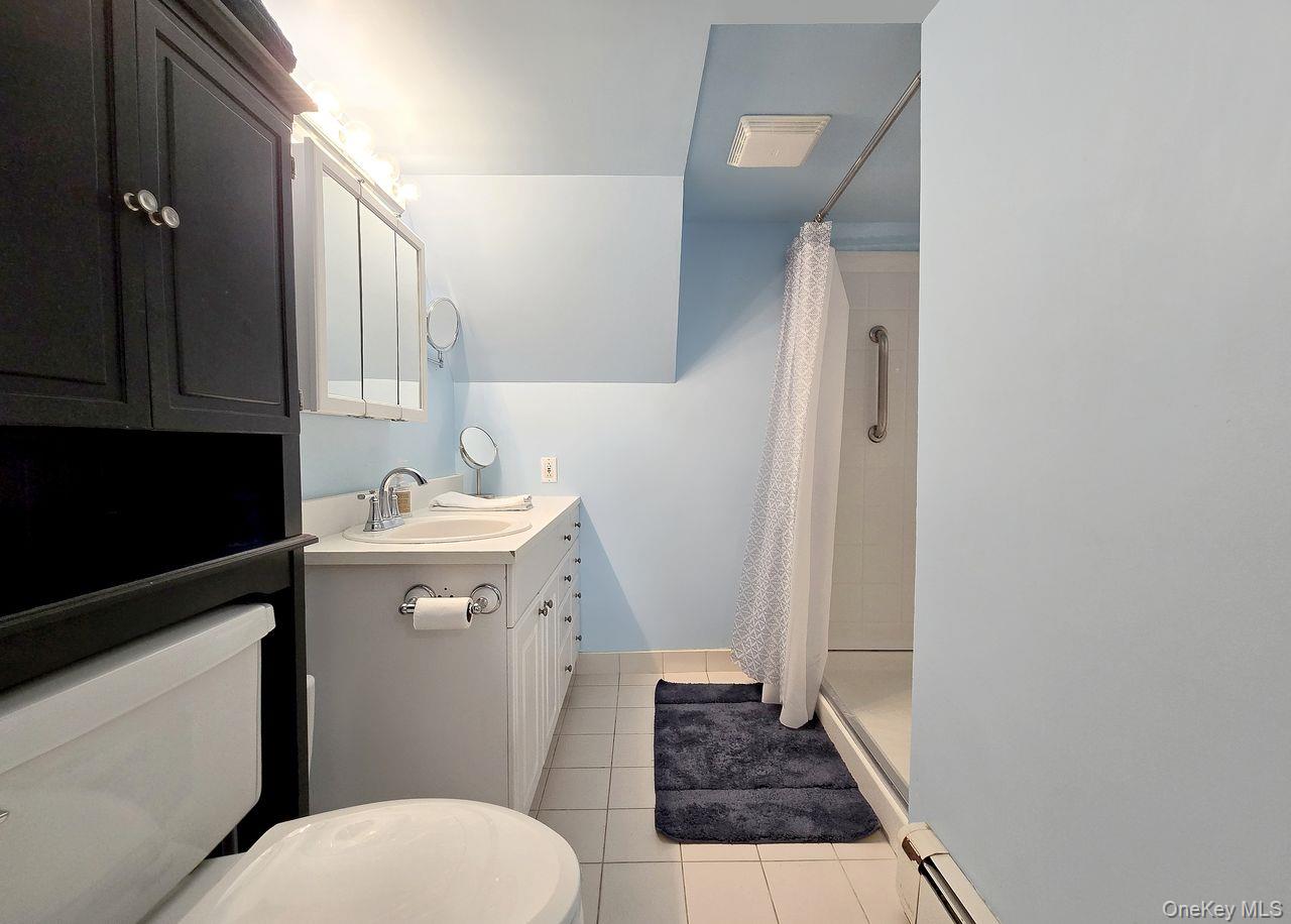 46 Harvest Lane Commack, NY 11725 - Photo 25 of 40 a bathroom with a sink toilet and shower