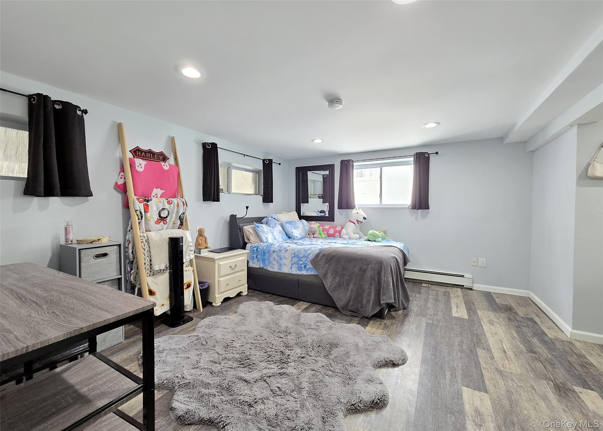 46 Harvest Lane Commack, NY 11725 - Photo 30 of 40 a bedroom with a bed and wooden floor