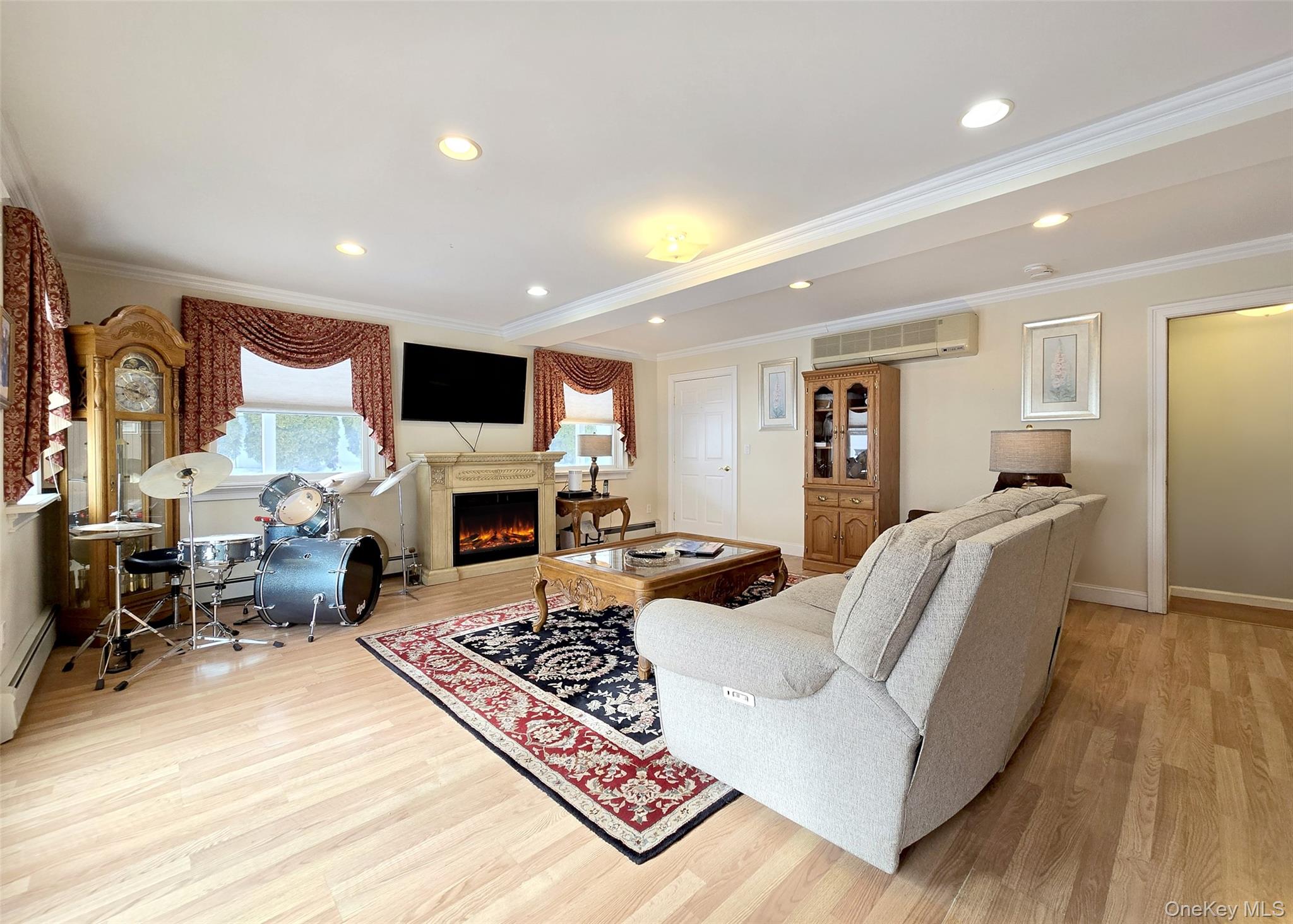 46 Harvest Lane Commack, NY 11725 - Photo 32 of 40 a living room with furniture and a fireplace