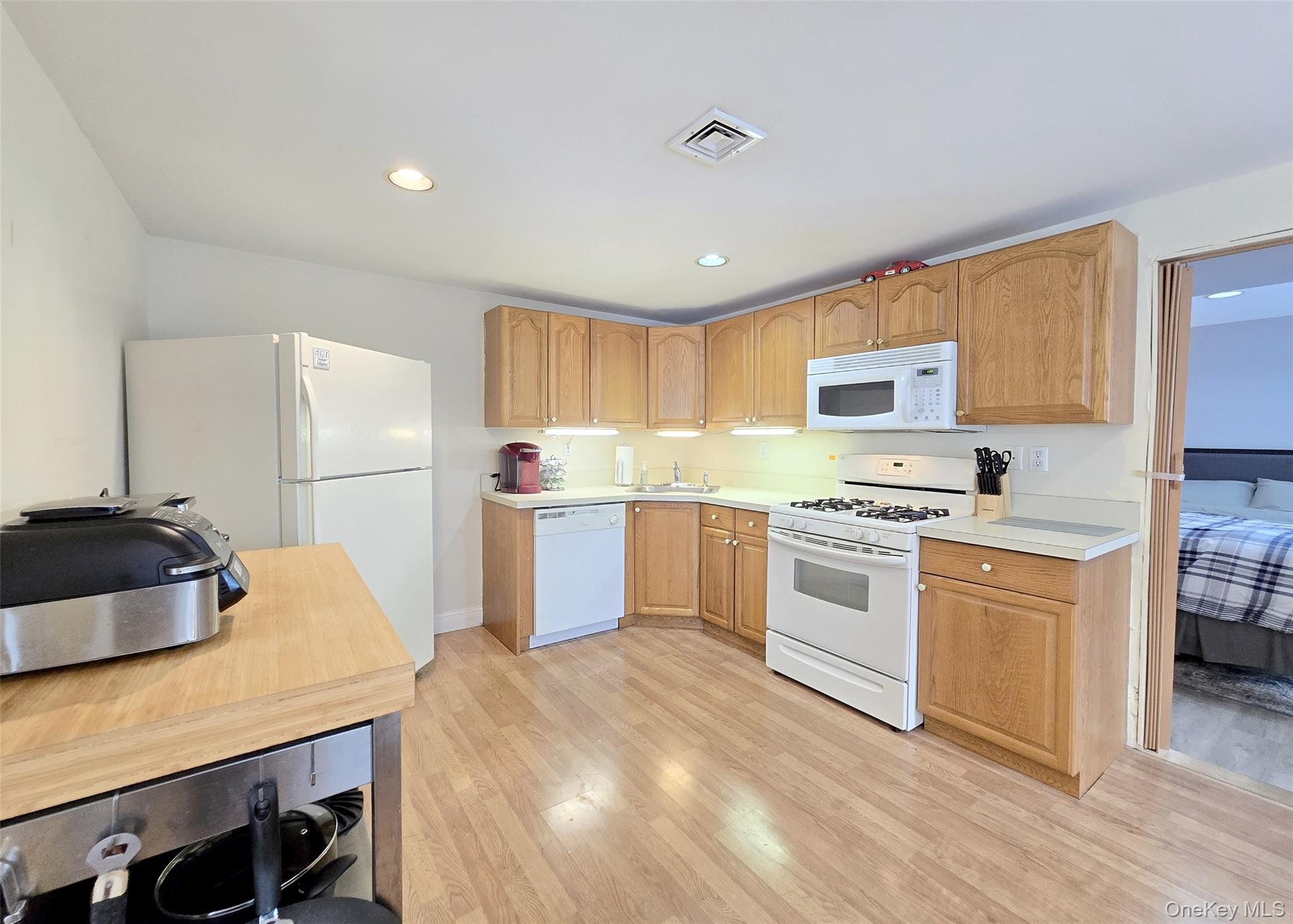 46 Harvest Lane Commack, NY 11725 - Photo 34 of 40 a kitchen with stainless steel appliances a refrigerator sink and microwave