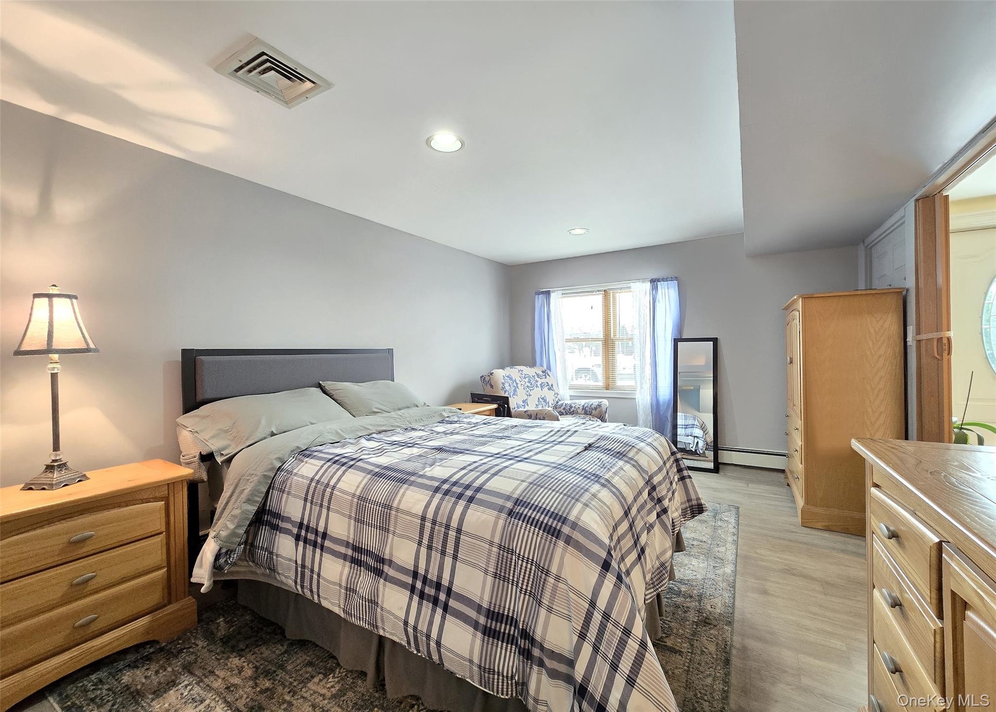 46 Harvest Lane Commack, NY 11725 - Photo 36 of 40 a bedroom with a bed and a night stand