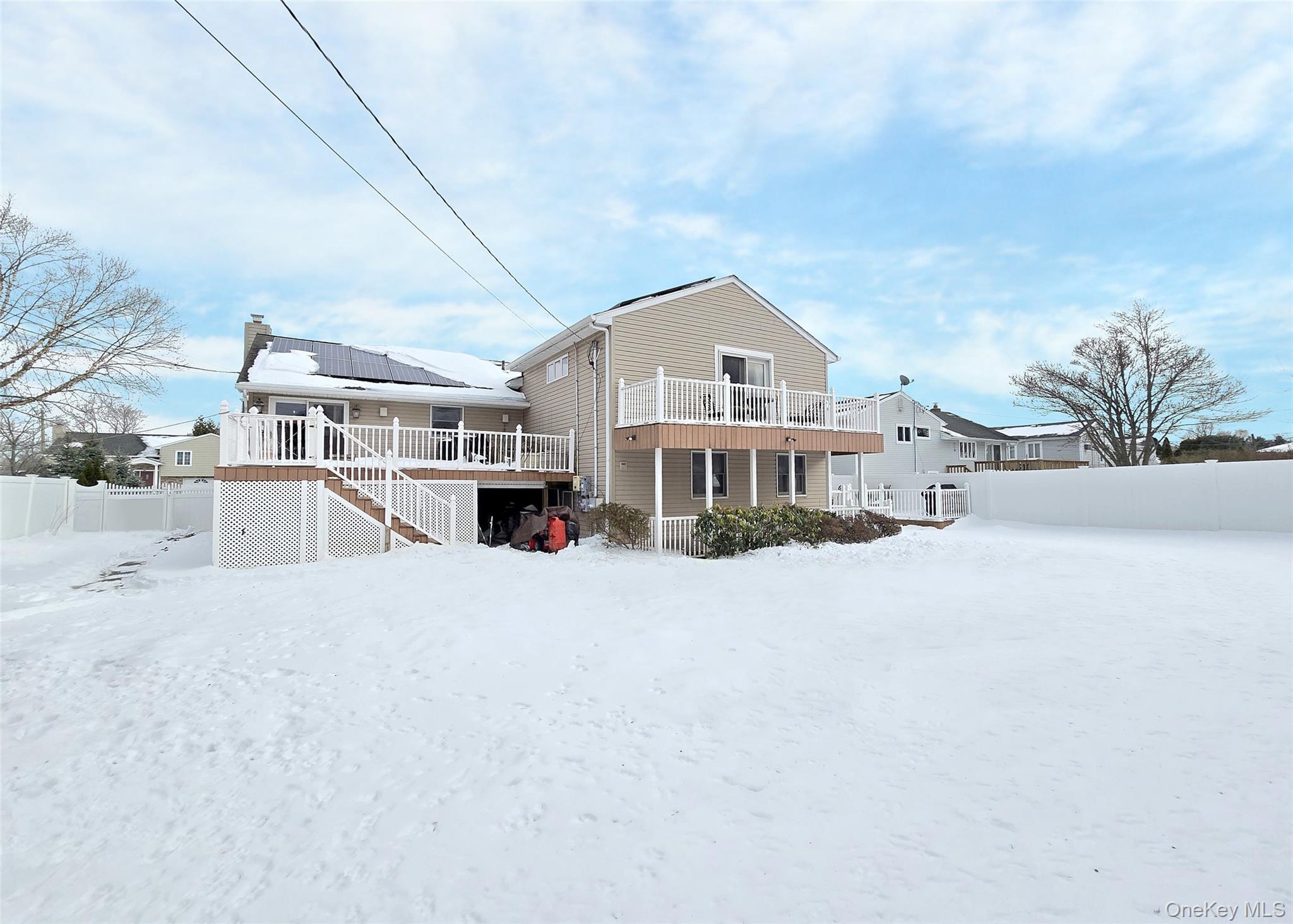 46 Harvest Lane Commack, NY 11725 - Photo 5 of 40 a view of a house with a large space and a big yard