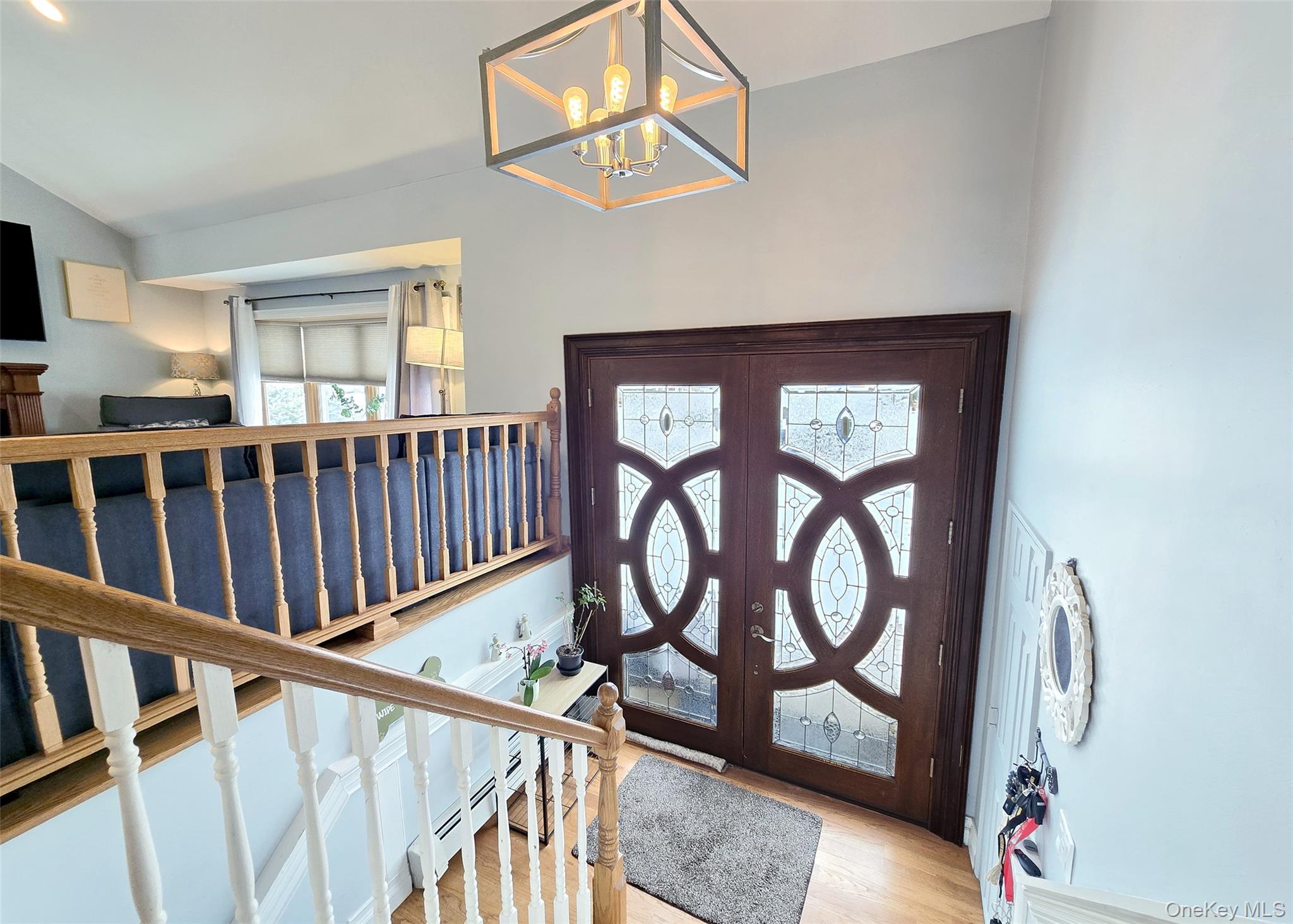 46 Harvest Lane Commack, NY 11725 - Photo 8 of 40 a view of staircase with wooden floor and a window