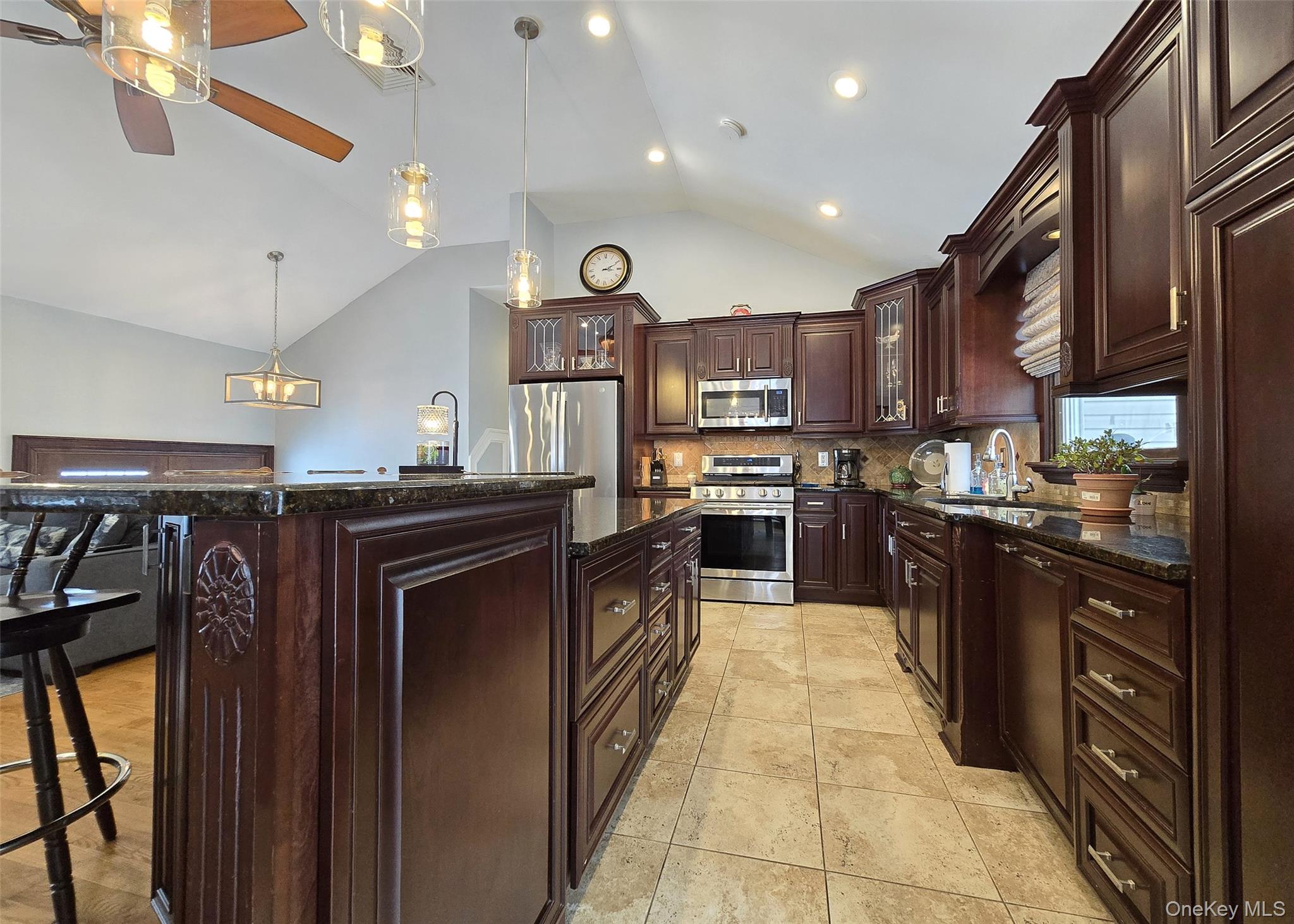 46 Harvest Lane Commack, NY 11725 - Photo 10 of 40 a large kitchen with stainless steel appliances kitchen island granite countertop a stove top oven a sink and dishwasher