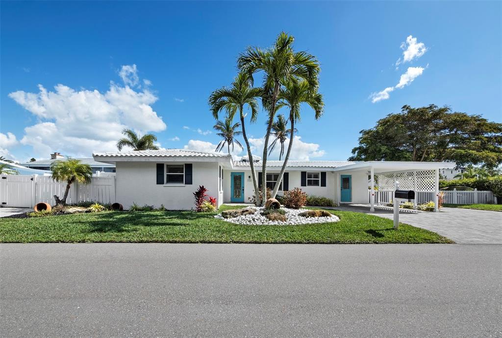 726 Jungle Queen Way Longboat Key, FL 34228 - Photo 1 of 43 a front view of a house with garden