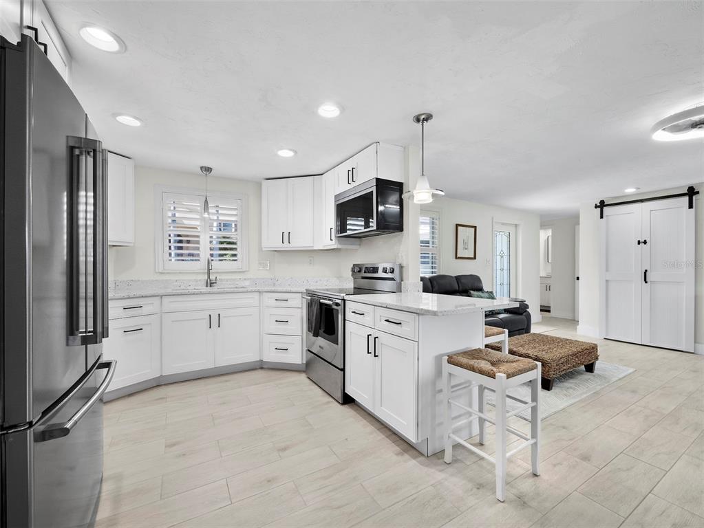 726 Jungle Queen Way Longboat Key, FL 34228 - Photo 11 of 43 a kitchen with granite countertop a refrigerator stove top oven and sink
