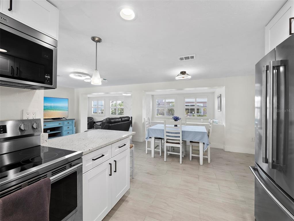 726 Jungle Queen Way Longboat Key, FL 34228 - Photo 13 of 43 a kitchen with a sink and chairs