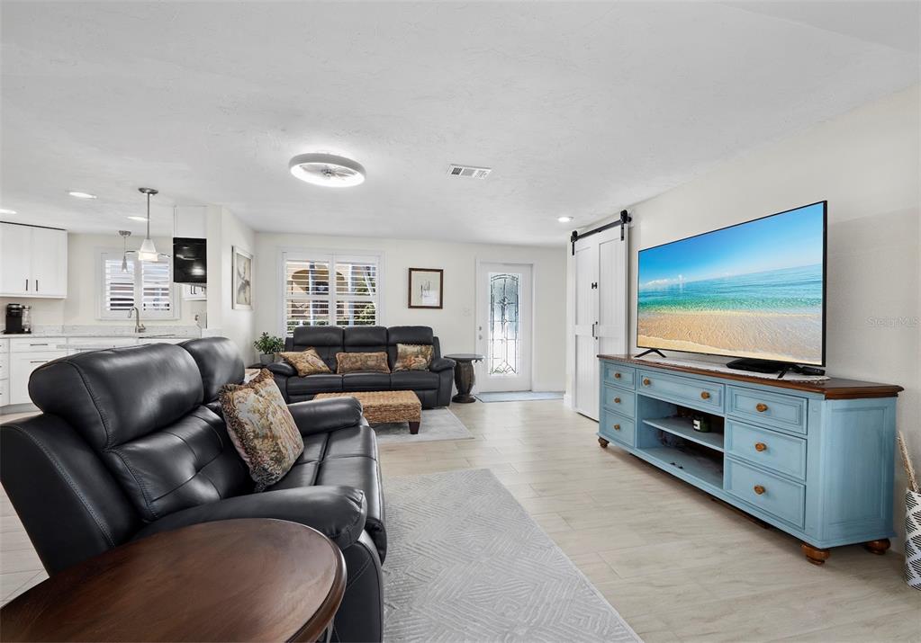 726 Jungle Queen Way Longboat Key, FL 34228 - Photo 15 of 43 a living room with furniture and a flat screen tv