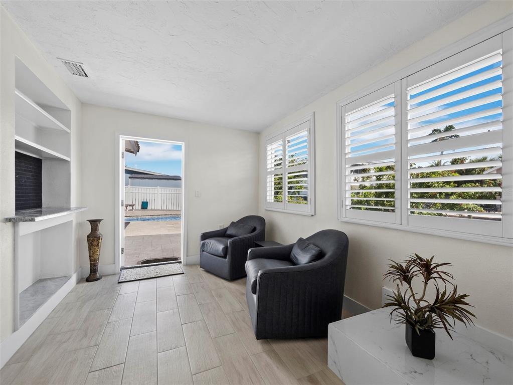 726 Jungle Queen Way Longboat Key, FL 34228 - Photo 17 of 43 a living room with furniture and a flat screen tv