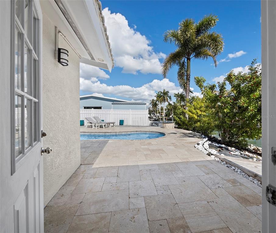 726 Jungle Queen Way Longboat Key, FL 34228 - Photo 18 of 43 a view of a pathway of a house with a yard and potted plants