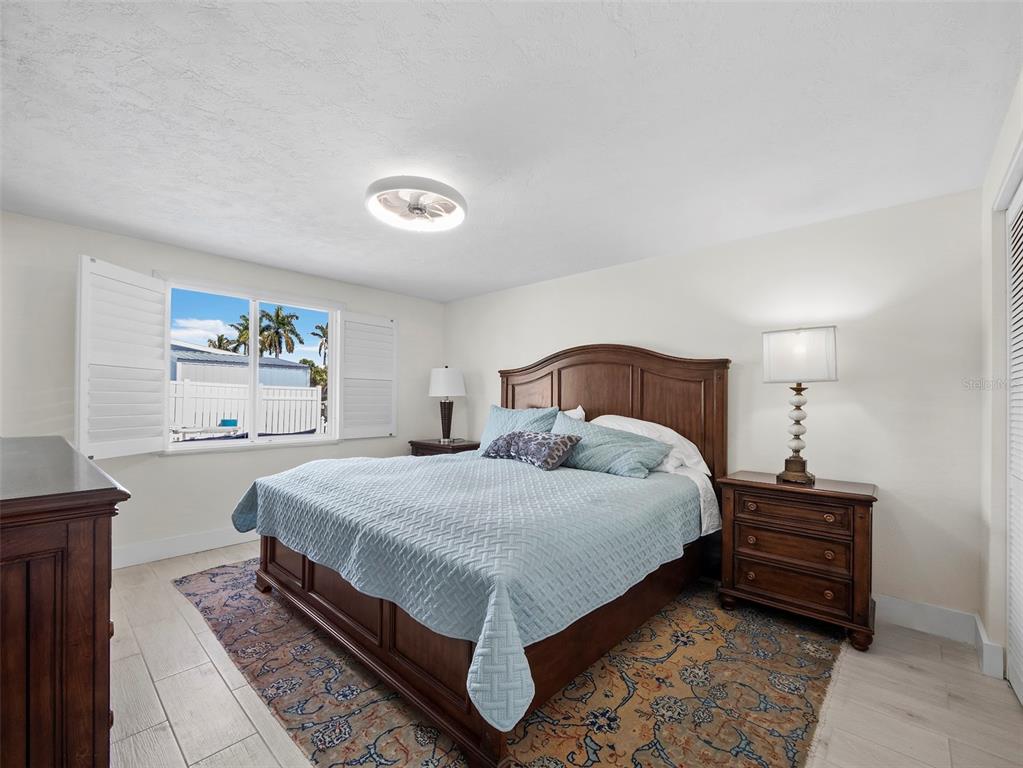 726 Jungle Queen Way Longboat Key, FL 34228 - Photo 19 of 43 a bedroom with a bed and dresser