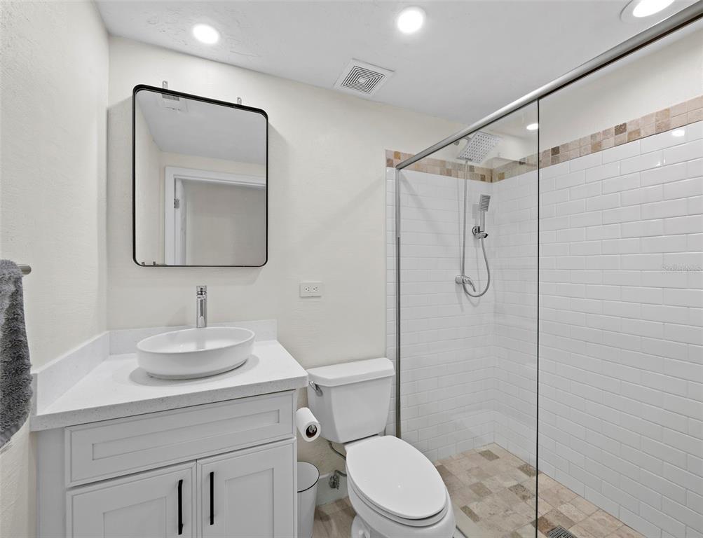 726 Jungle Queen Way Longboat Key, FL 34228 - Photo 22 of 43 a bathroom with a toilet sink vanity and mirror