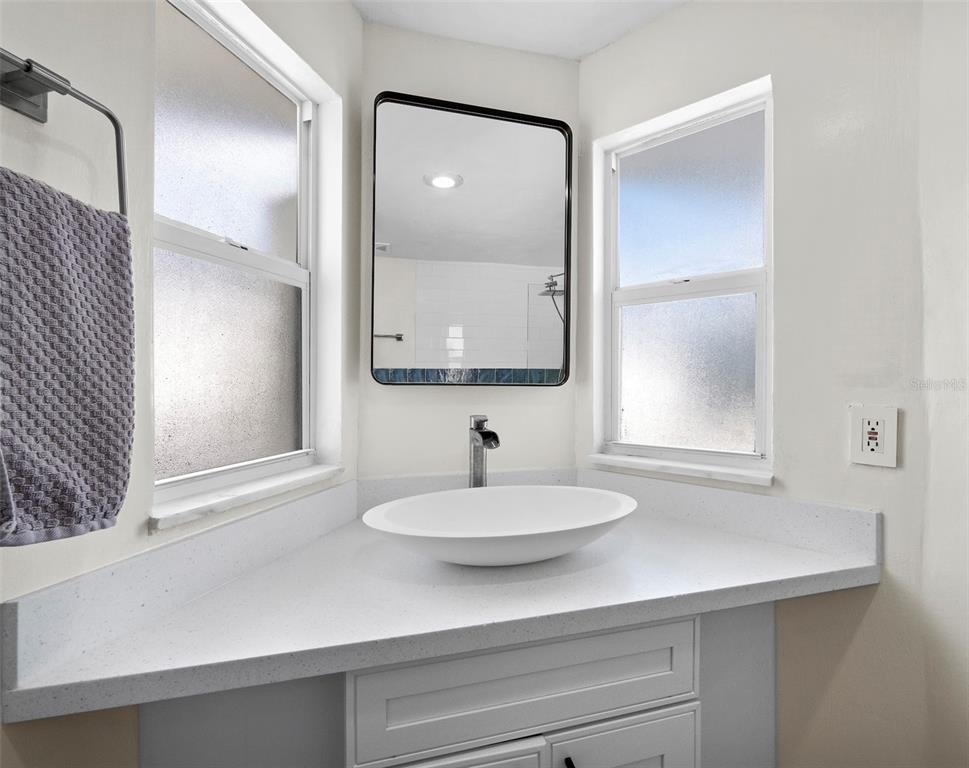 726 Jungle Queen Way Longboat Key, FL 34228 - Photo 25 of 43 a bathroom with a sink and a mirror