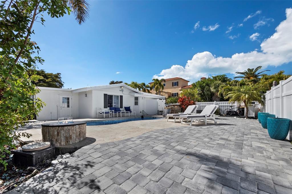726 Jungle Queen Way Longboat Key, FL 34228 - Photo 32 of 43 a view of a house with backyard and sitting area