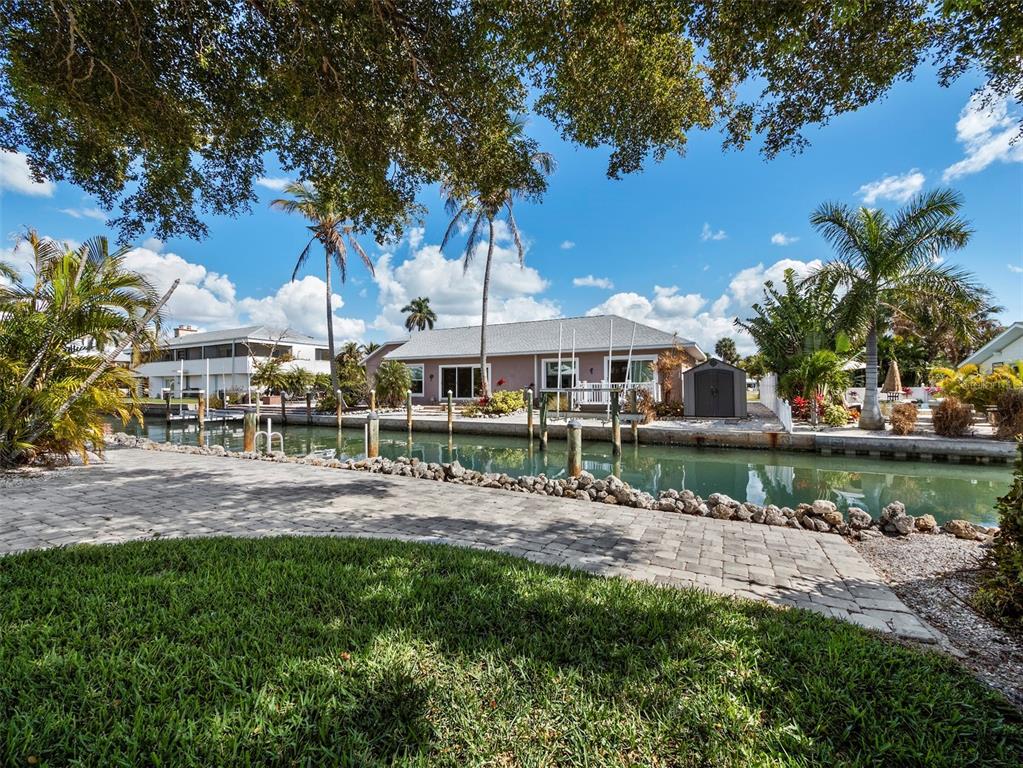 726 Jungle Queen Way Longboat Key, FL 34228 - Photo 34 of 43 a view of a house with a yard and sitting area