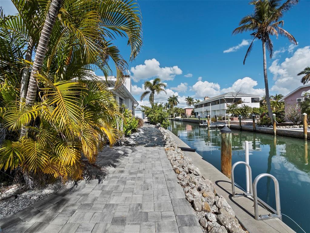 726 Jungle Queen Way Longboat Key, FL 34228 - Photo 35 of 43 a view of a lake with a palm trees
