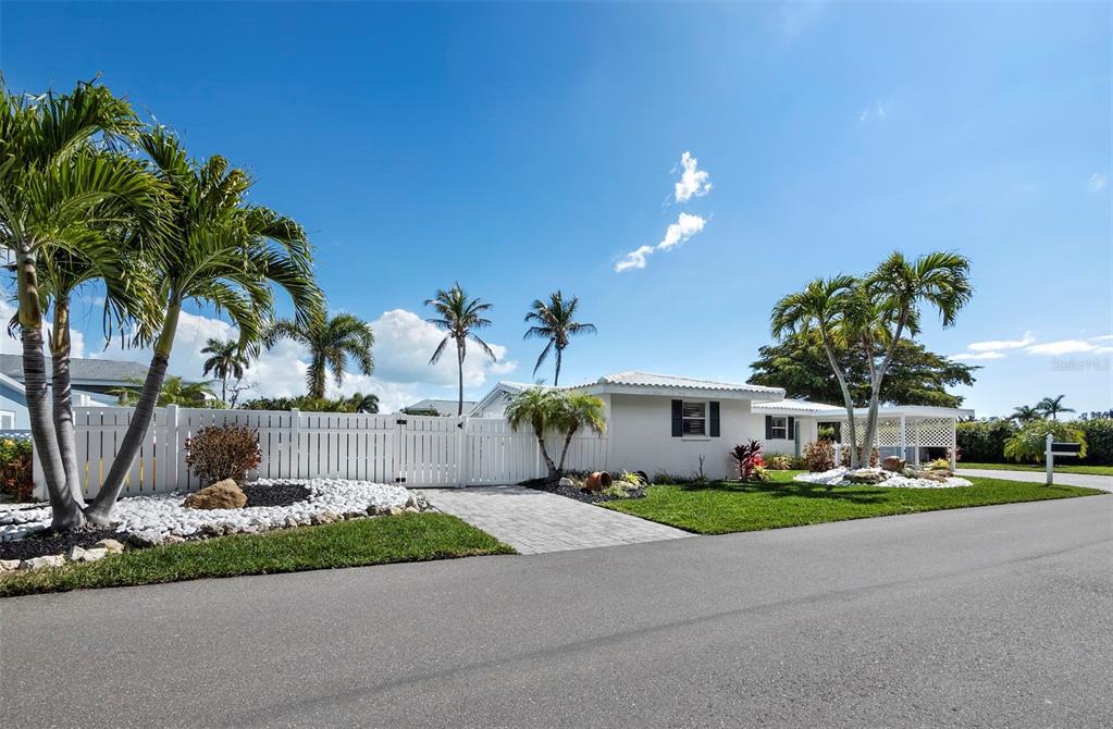 726 Jungle Queen Way Longboat Key, FL 34228 - Photo 36 of 43 a front view of a house with garden and trees