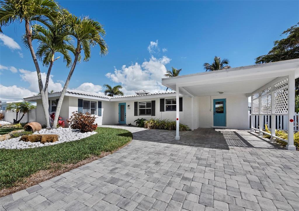 726 Jungle Queen Way Longboat Key, FL 34228 - Photo 37 of 43 a front view of a house with garden and porch