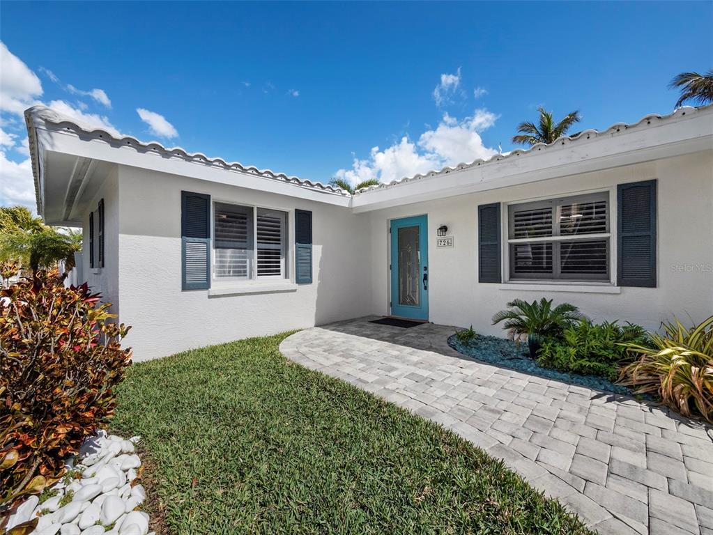 726 Jungle Queen Way Longboat Key, FL 34228 - Photo 38 of 43 a front view of a house with garden