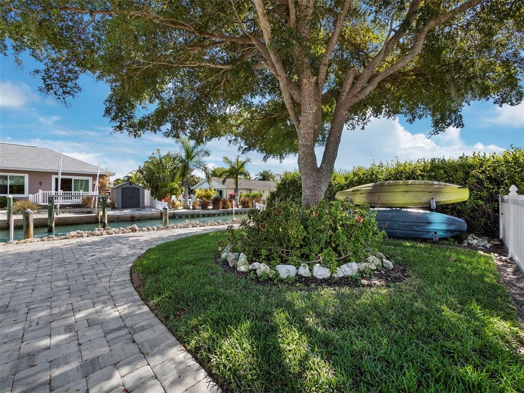 726 Jungle Queen Way Longboat Key, FL 34228 - Photo 40 of 43 a view of a backyard with garden and plants