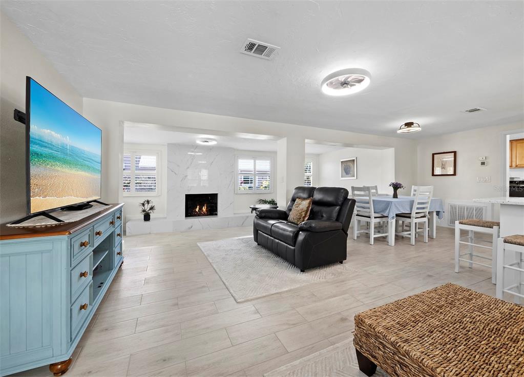 726 Jungle Queen Way Longboat Key, FL 34228 - Photo 4 of 43 a living room with furniture flat screen tv and kitchen view