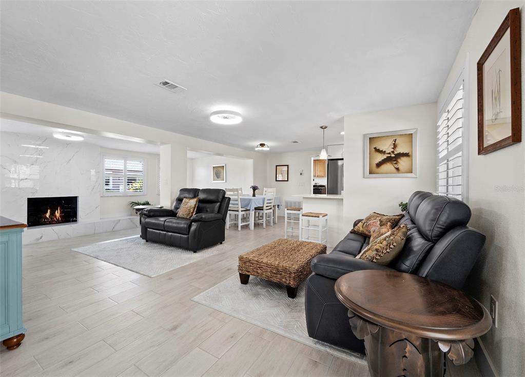 726 Jungle Queen Way Longboat Key, FL 34228 - Photo 5 of 43 a living room with furniture and a fireplace