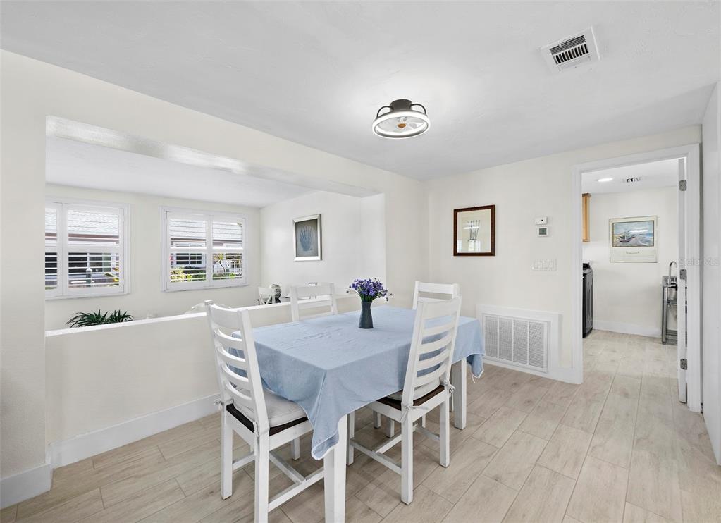 726 Jungle Queen Way Longboat Key, FL 34228 - Photo 9 of 43 a view of a dining room with furniture and wooden floor