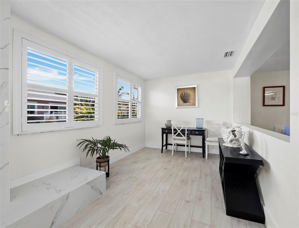 726 Jungle Queen Way Longboat Key, FL 34228 - Photo 10 of 43 a living room with furniture and a potted plant