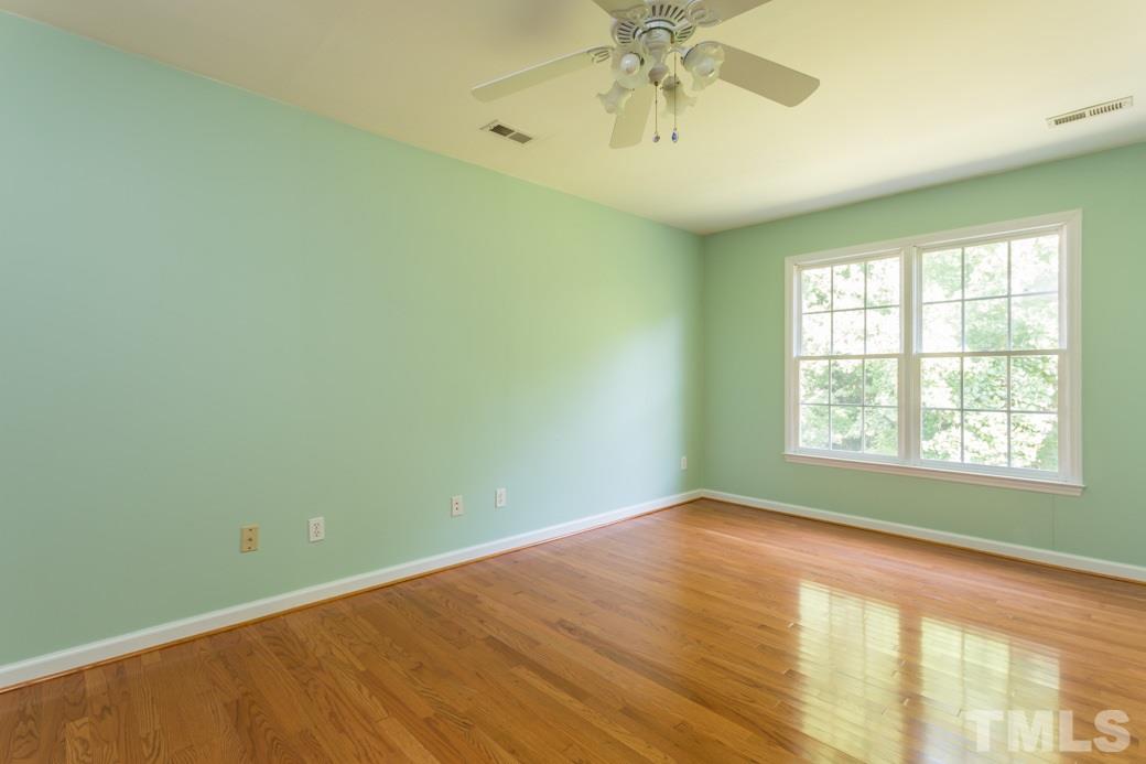 8620 Erinsbrook Drive Raleigh, NC 27617 - Photo 12 of 25 a view of an empty room with chandelier fan and a window