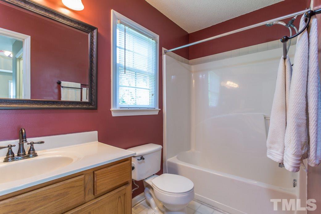 8620 Erinsbrook Drive Raleigh, NC 27617 - Photo 16 of 25 a bathroom with a sink toilet vanity and shower