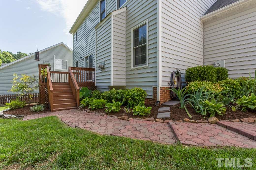 8620 Erinsbrook Drive Raleigh, NC 27617 - Photo 20 of 25 a view of a house with a yard and a garden