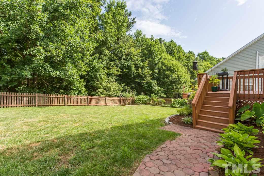 8620 Erinsbrook Drive Raleigh, NC 27617 - Photo 24 of 25 a view of a backyard with large trees