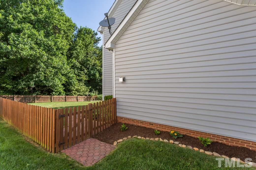 8620 Erinsbrook Drive Raleigh, NC 27617 - Photo 4 of 25 a view of a backyard with a fence