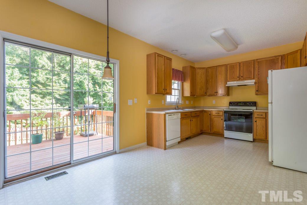 8620 Erinsbrook Drive Raleigh, NC 27617 - Photo 5 of 25 a kitchen with a refrigerator a sink and cabinets
