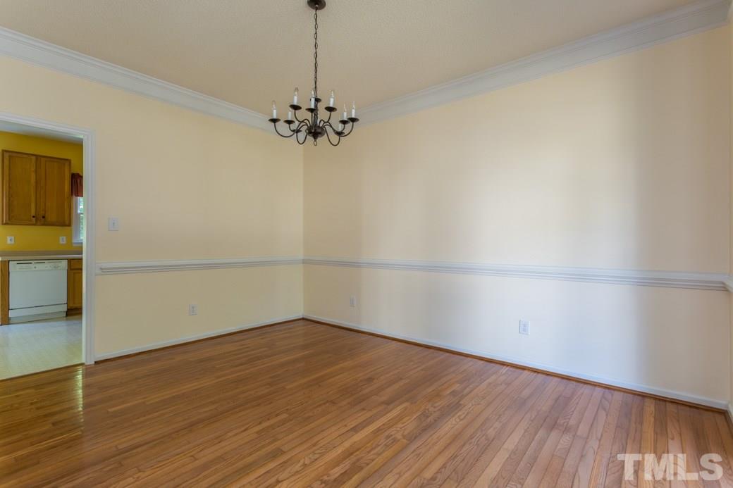 8620 Erinsbrook Drive Raleigh, NC 27617 - Photo 8 of 25 a view of a room with wooden floor and a window