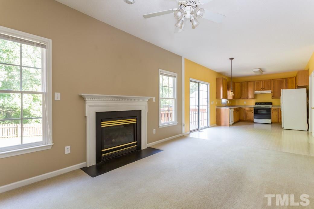 8620 Erinsbrook Drive Raleigh, NC 27617 - Photo 10 of 25 a living room with furniture and a fireplace