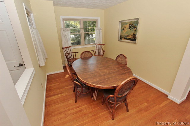 80 Deer Run Road Lancaster, VA 22503 - Photo 9 of 32 a view of a dining room with furniture and wooden floor