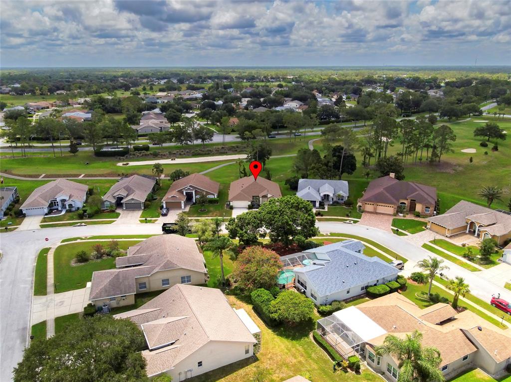 11228 Windrush Circle Hudson, FL 34667 - Photo 52 of 67 an aerial view of residential houses with outdoor space and lake view