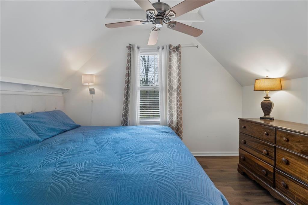 243 Bluegill Road Eatonton, GA 31024 - Photo 28 of 54 a bedroom with a bed and a chandelier