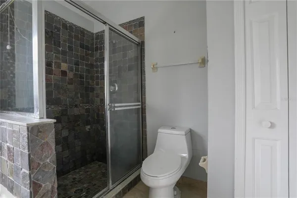 a bathroom with a toilet and a shower