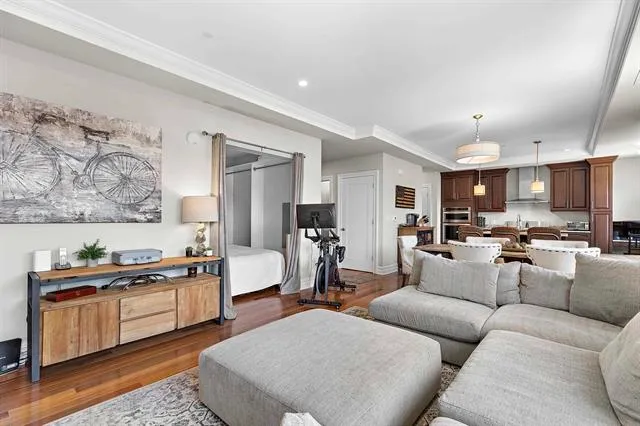 a living room with furniture and kitchen view