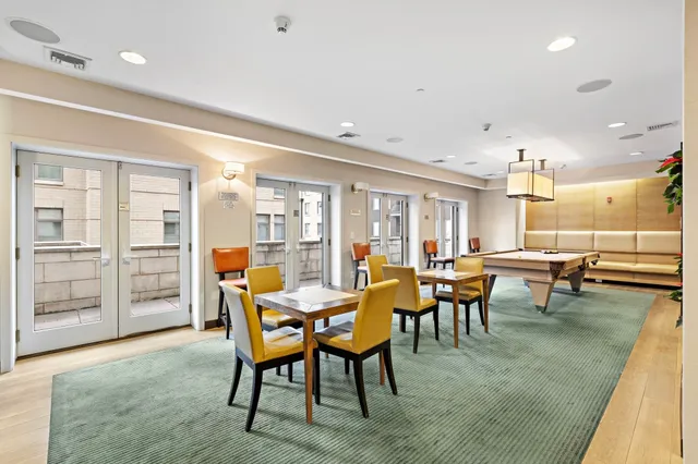 a living room with furniture pool table and a table
