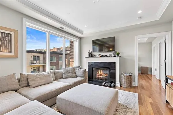 a living room with furniture flat screen tv and a fireplace