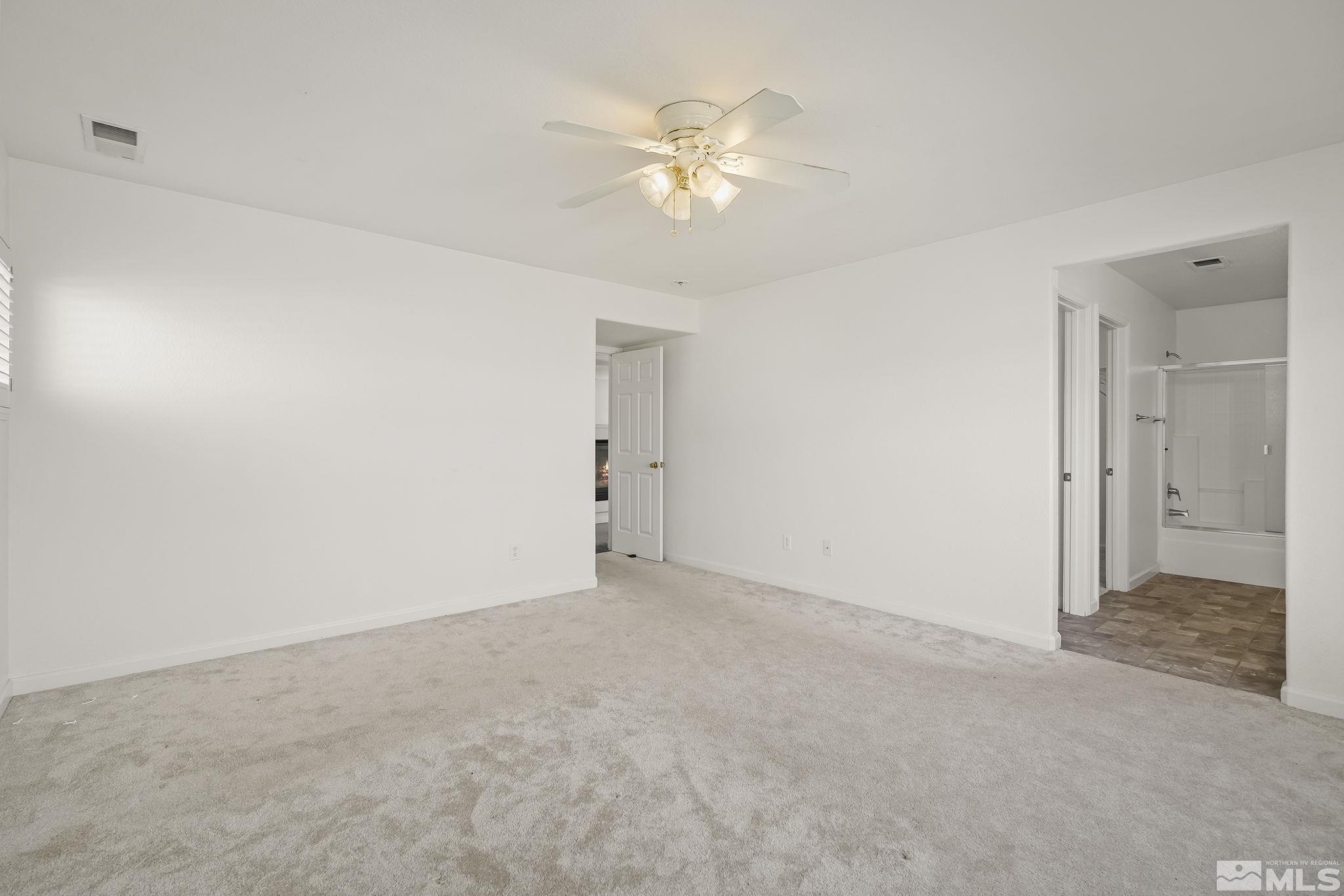 7859 Tulear Street Reno, NV 89506 - Photo 13 of 19 a view of an empty room with a ceiling fan