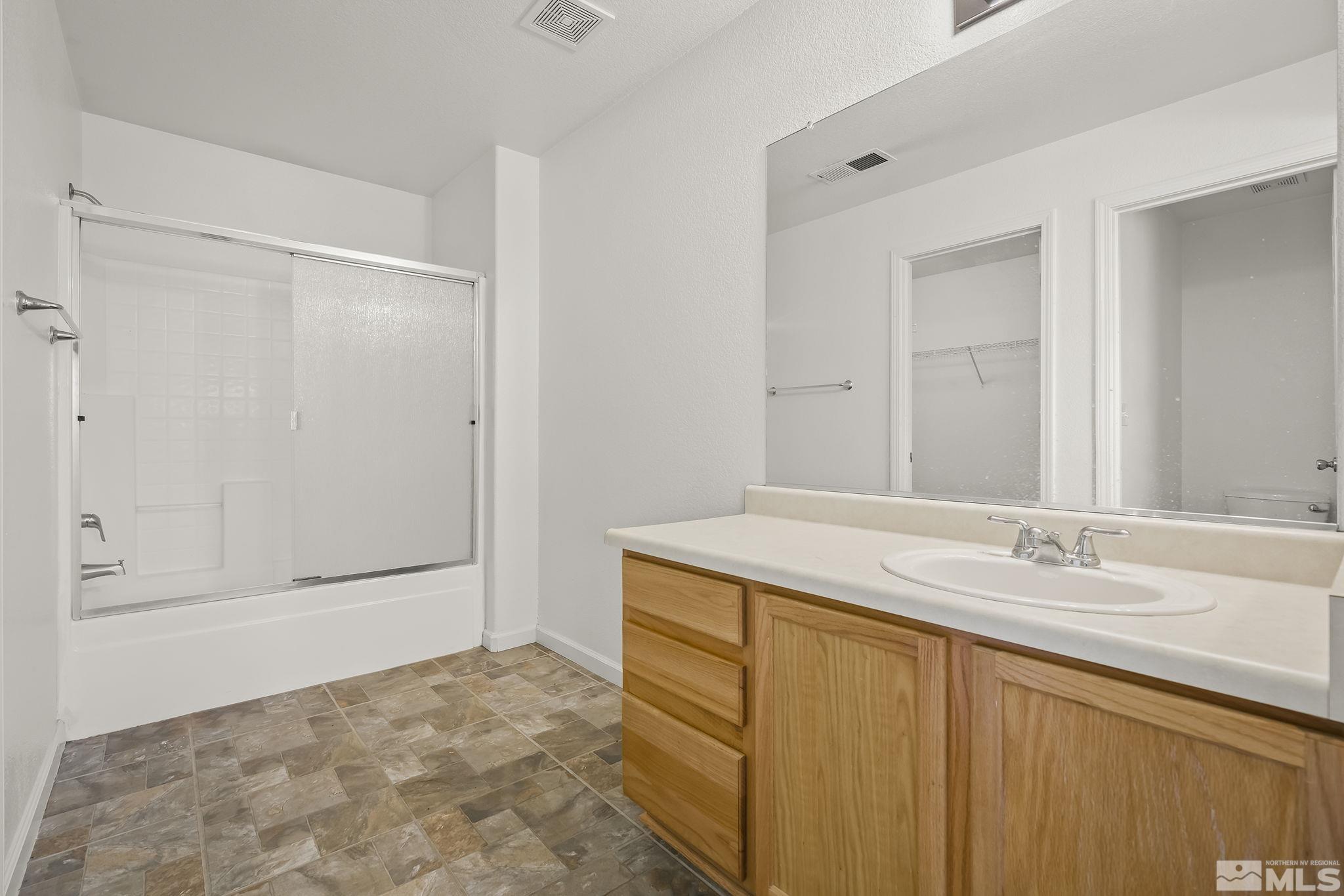 7859 Tulear Street Reno, NV 89506 - Photo 14 of 19 a bathroom with a sink and a mirror