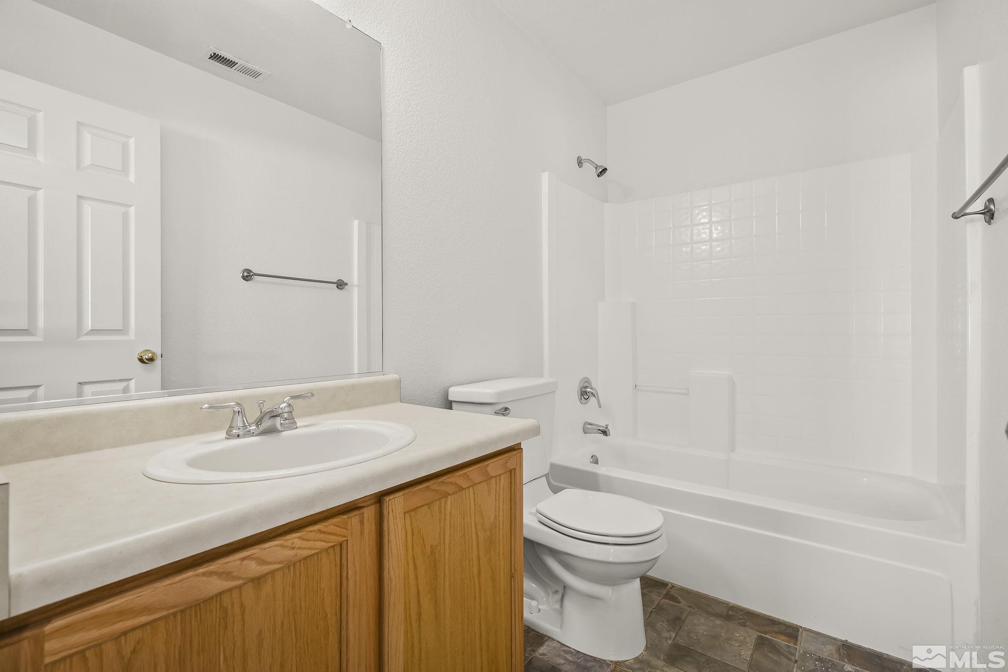 7859 Tulear Street Reno, NV 89506 - Photo 17 of 19 a bathroom with a sink a toilet and shower