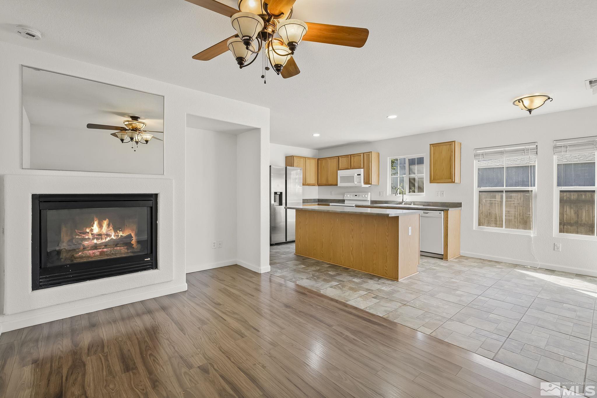 7859 Tulear Street Reno, NV 89506 - Photo 7 of 19 a view of kitchen with granite countertop cabinets and outdoor space