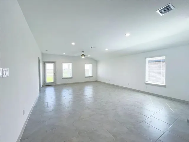 an empty room with windows and entrance