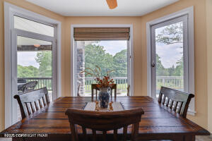17 Cricket Hill Road Hawley, PA 18428 - Photo 17 of 93 a view of a dining room with furniture wooden floor and a potted plant